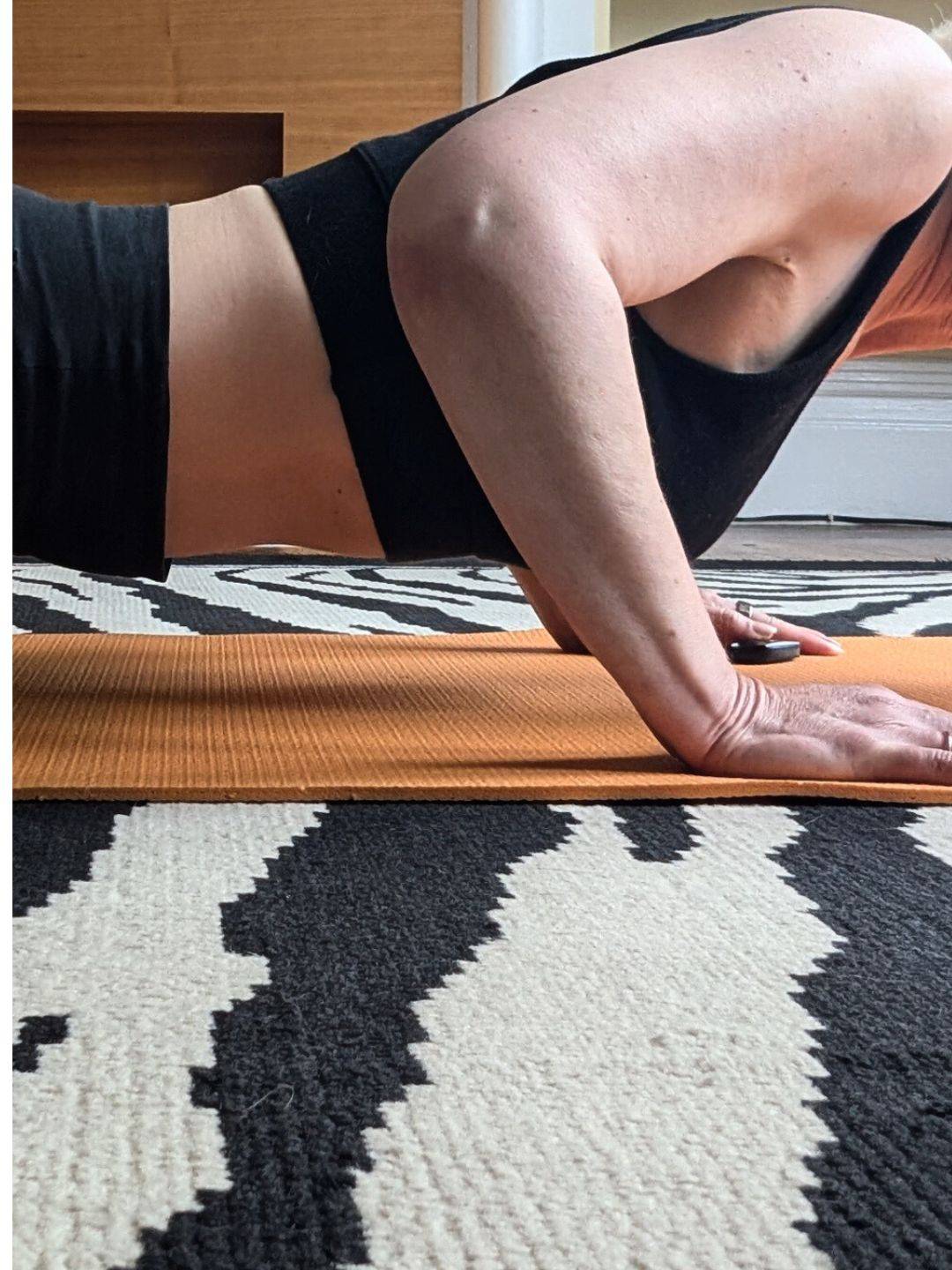 close up of woman's torso and arms while doing push up