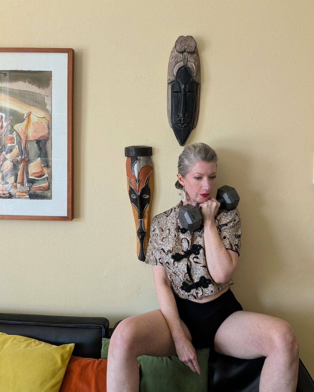 woman holding weight while looking pensive