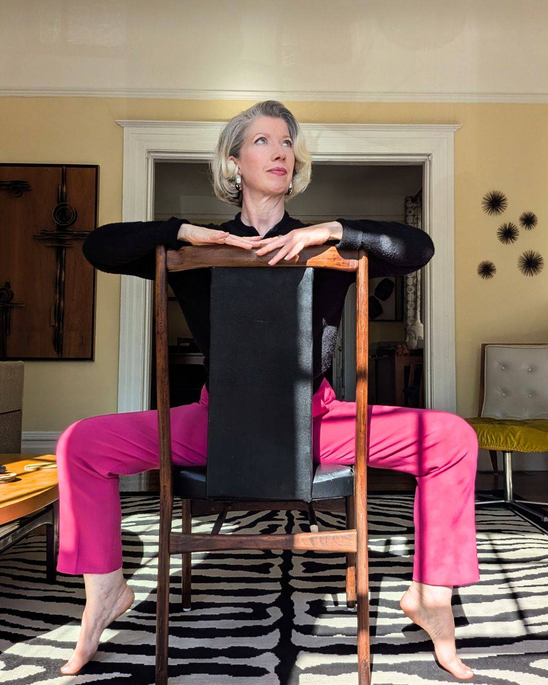 woman sitting backwards on chair
