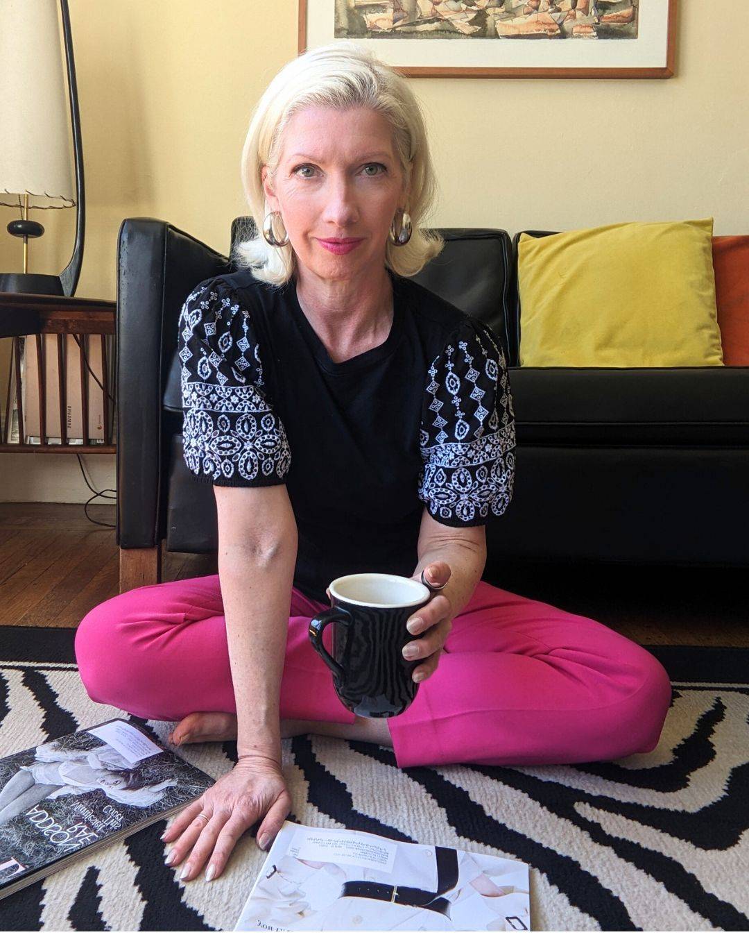 woman sitting on floor holding coffee cup