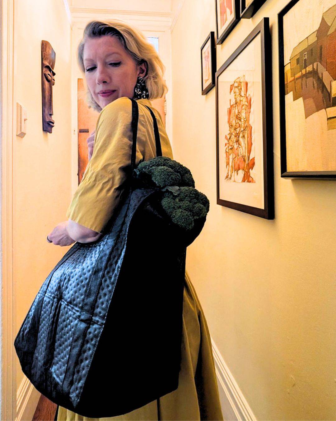 woman walking out door carrying groceries