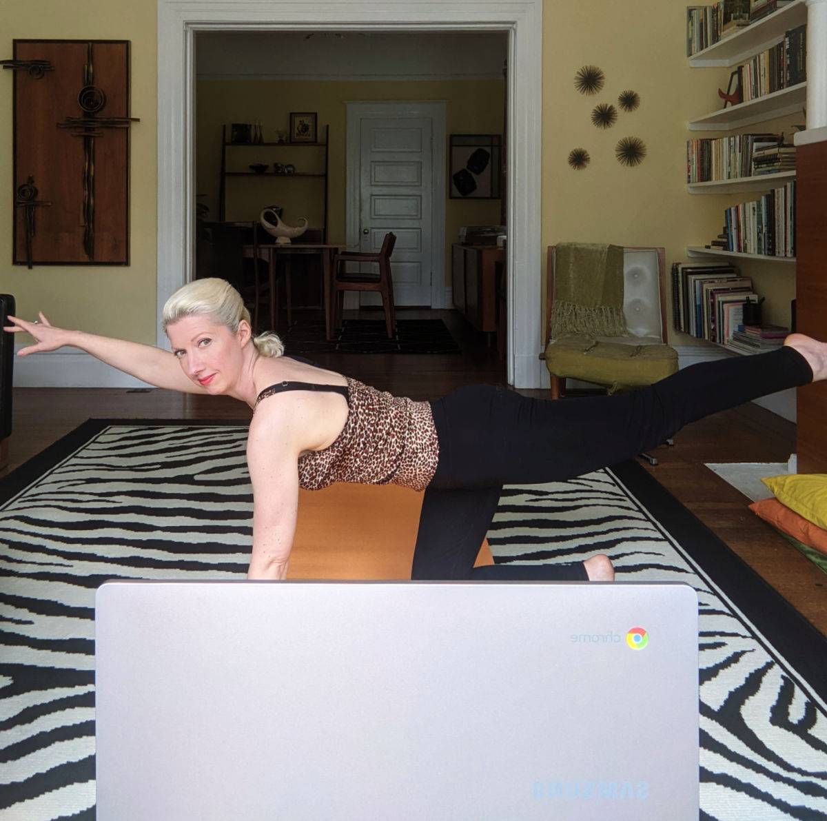 woman exercising in front of computer