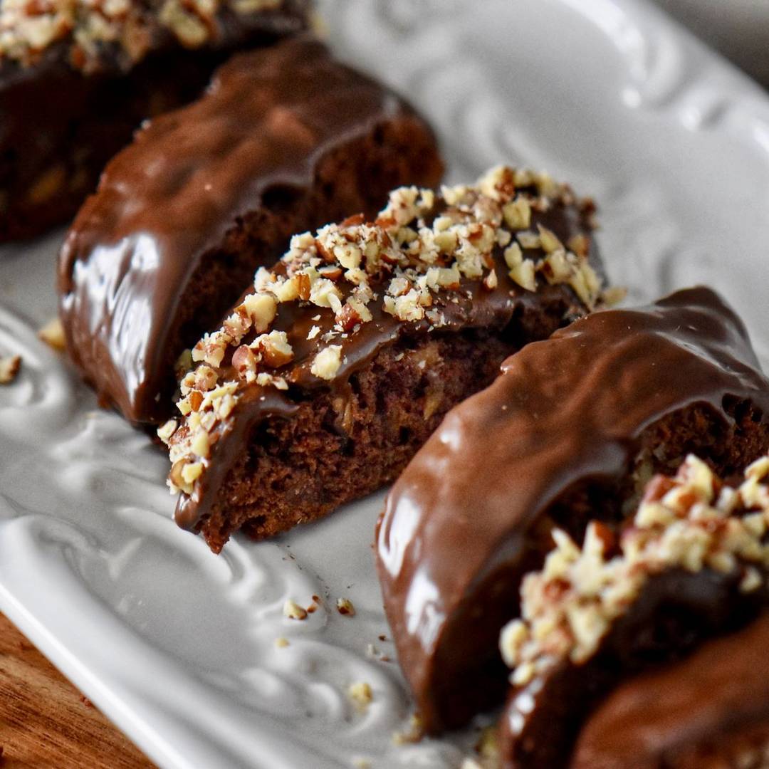 Chocolate biscotti on a white cookie tray.