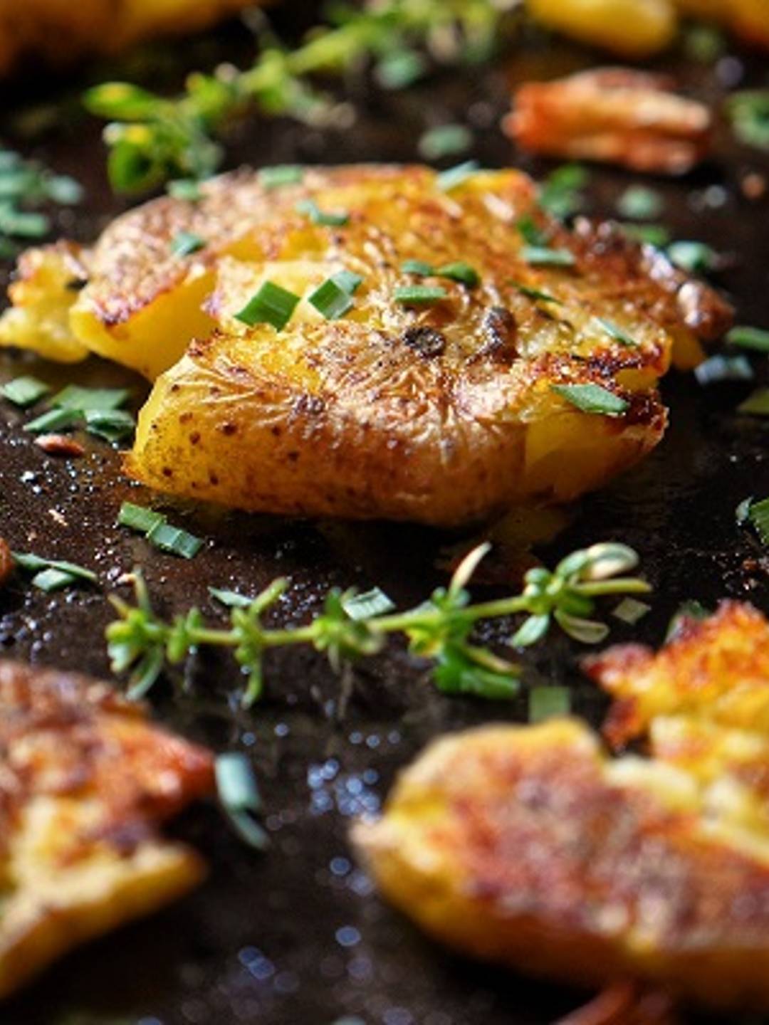 Smashed potatoes on a sheet pan.