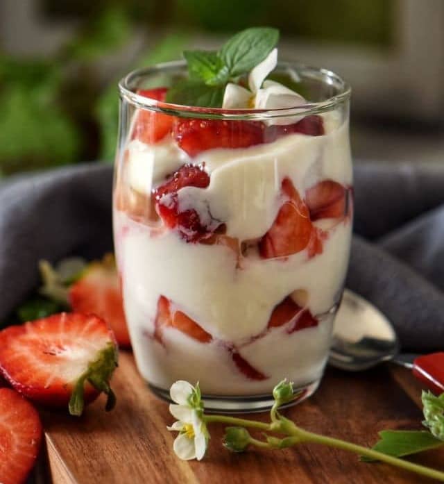 Strawberries and ricotta in a dessert glass.