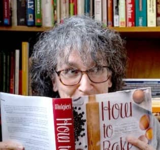 woman looking at cookbook