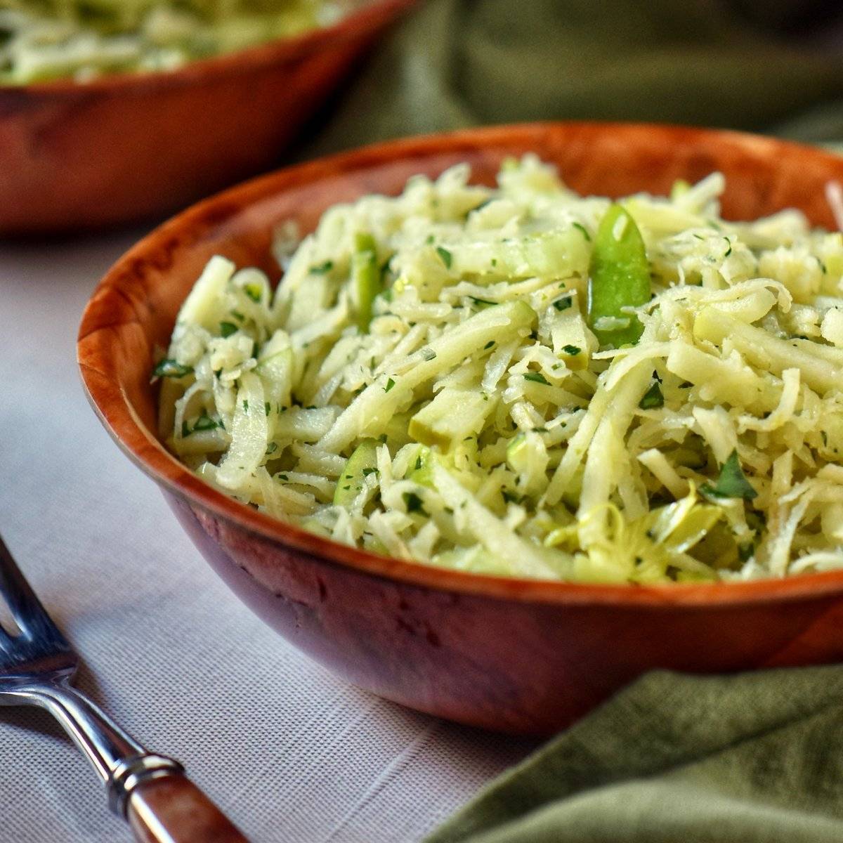 Celery root slaw in a brown salad bowl