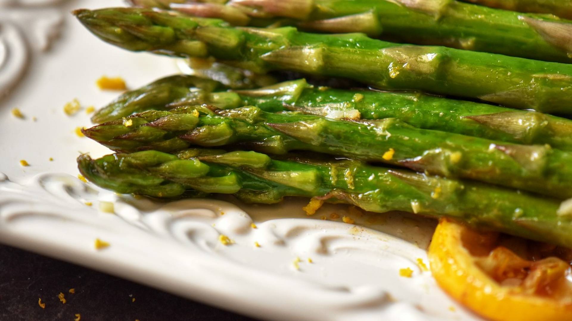 Asparagus on a white serving platter.