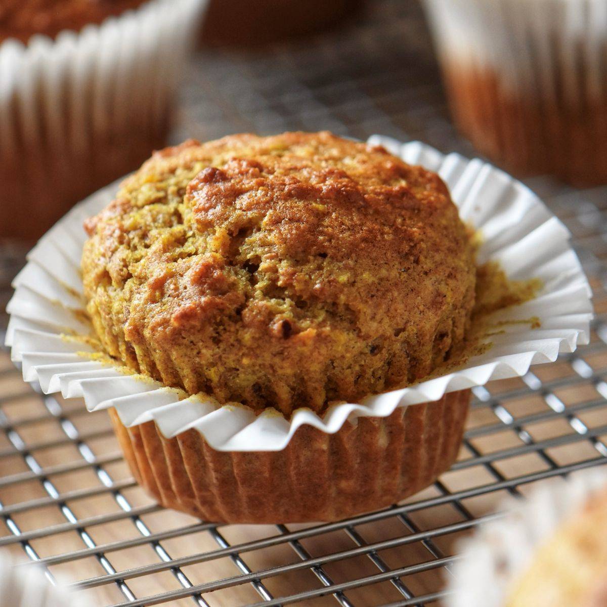 Orange date muffins on a cooling rack.