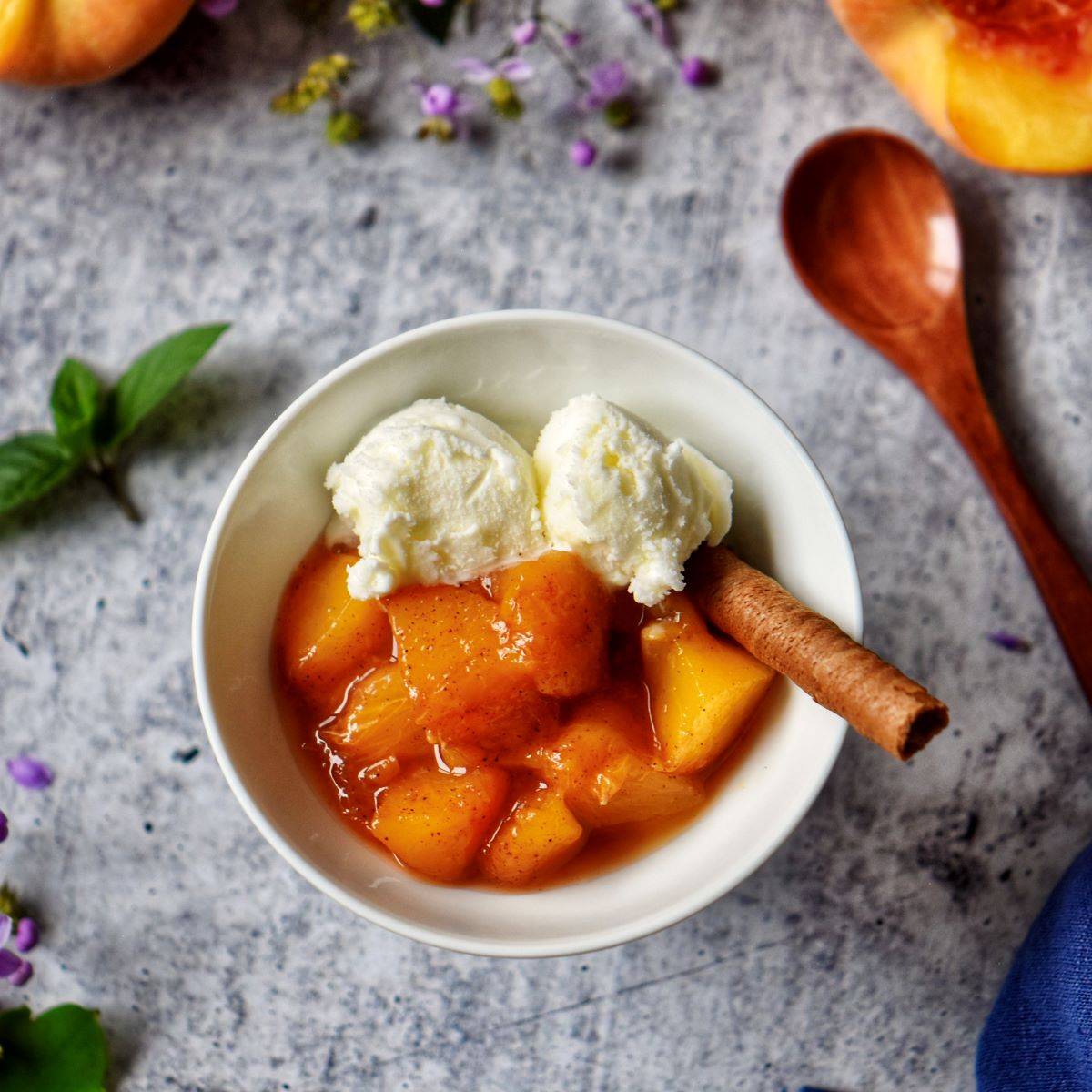Peach compote in a white dessert bowl.