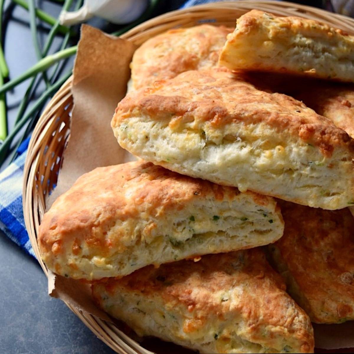 A few cheddar cheese biscuits in a wicker basket.