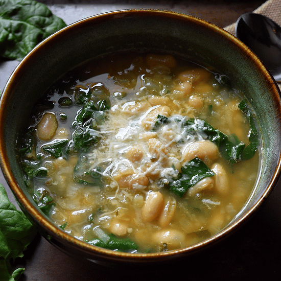 A big white bowl of White Kidney Bean and Spinach Soup.