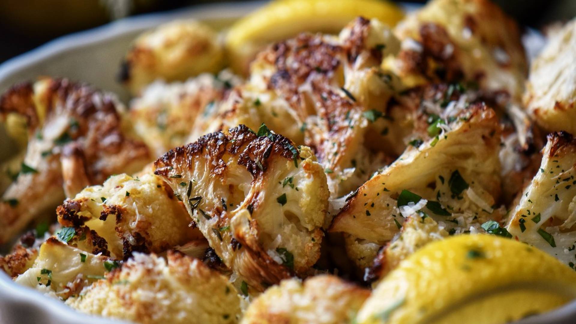 Oven roasted cauliflower in a white dish.
