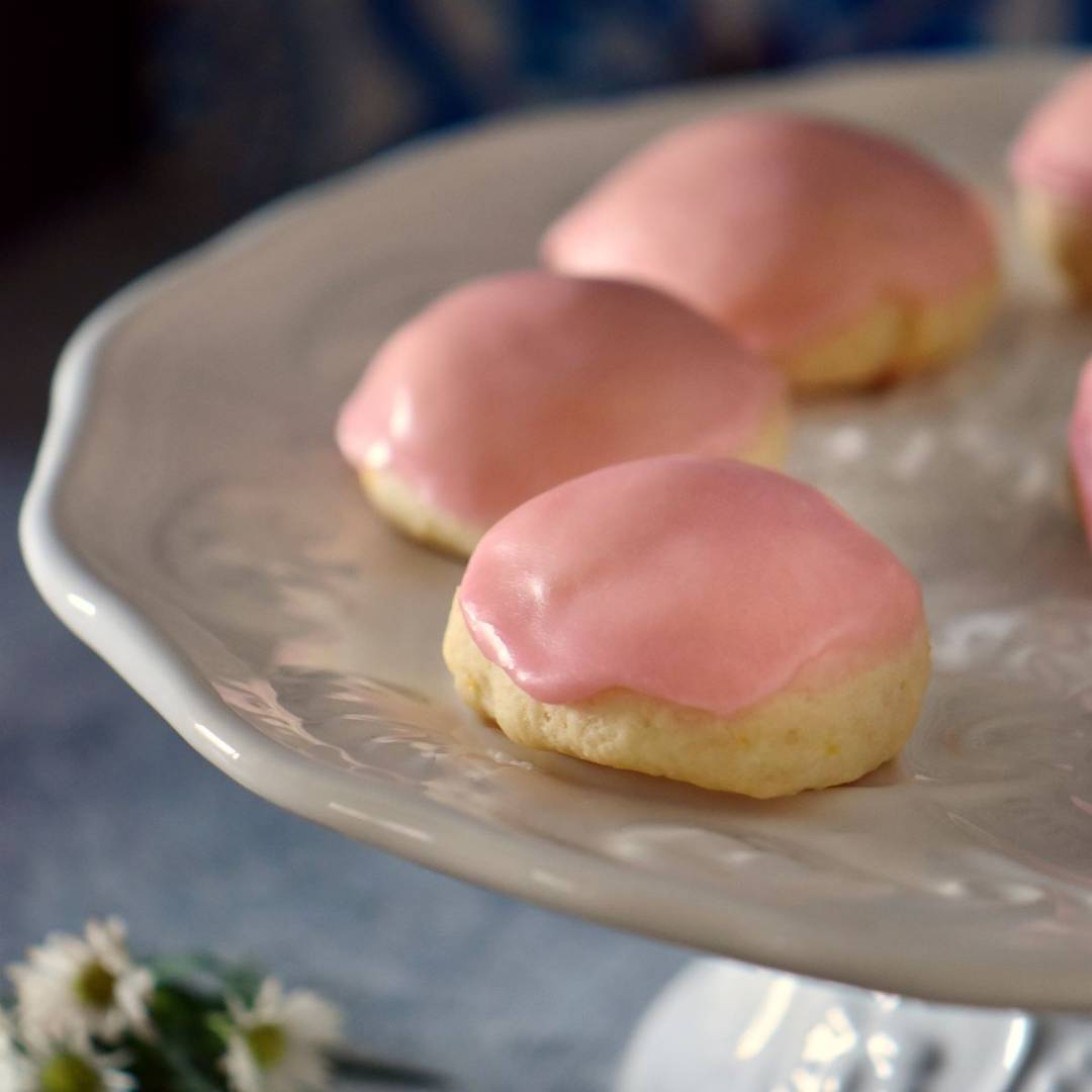Ricotta cookies on a white platter.