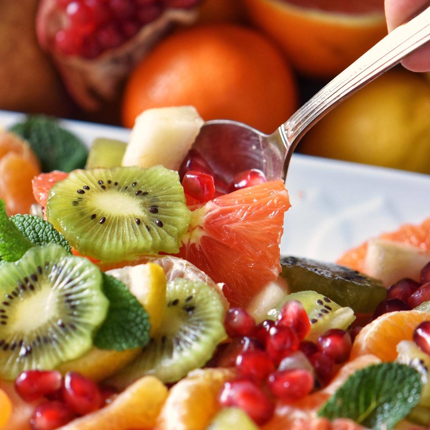 Fruit salad on a white platter.