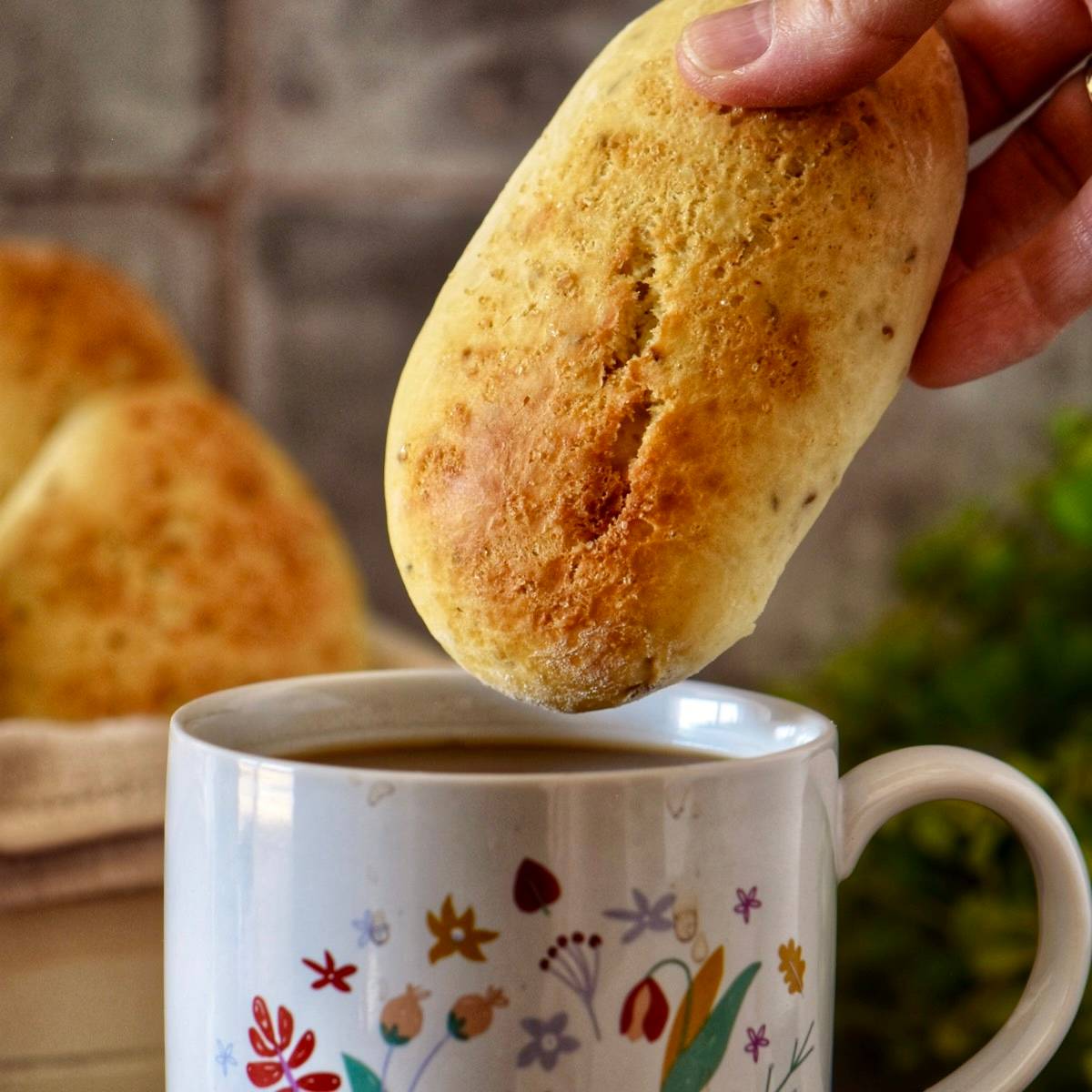 An Italian cookie being dunked in coffee.