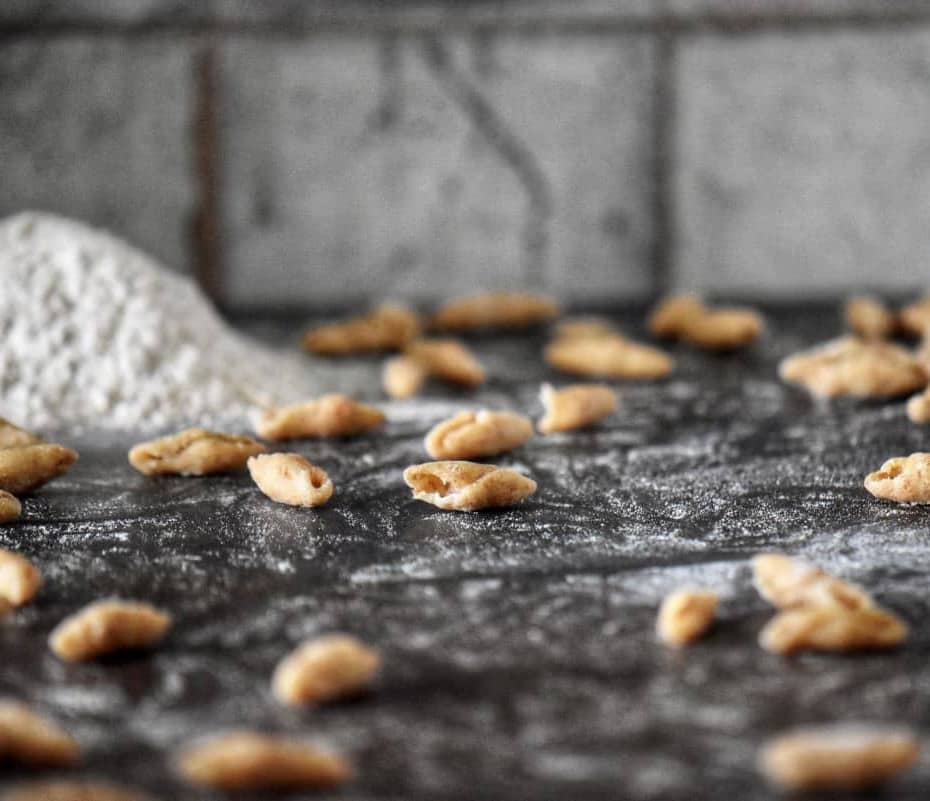 Whole wheat cavatelli on a floured surface.