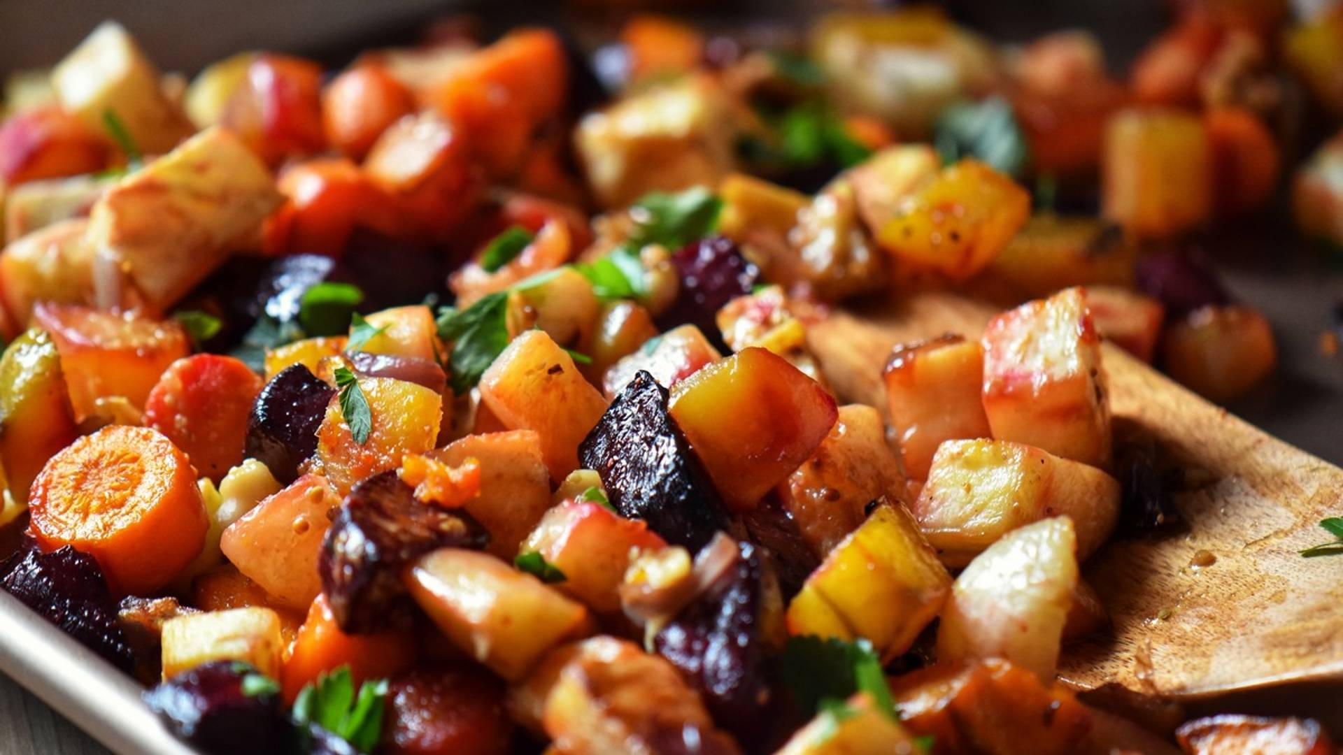 Oven roasted root vegetables on a sheet pan.