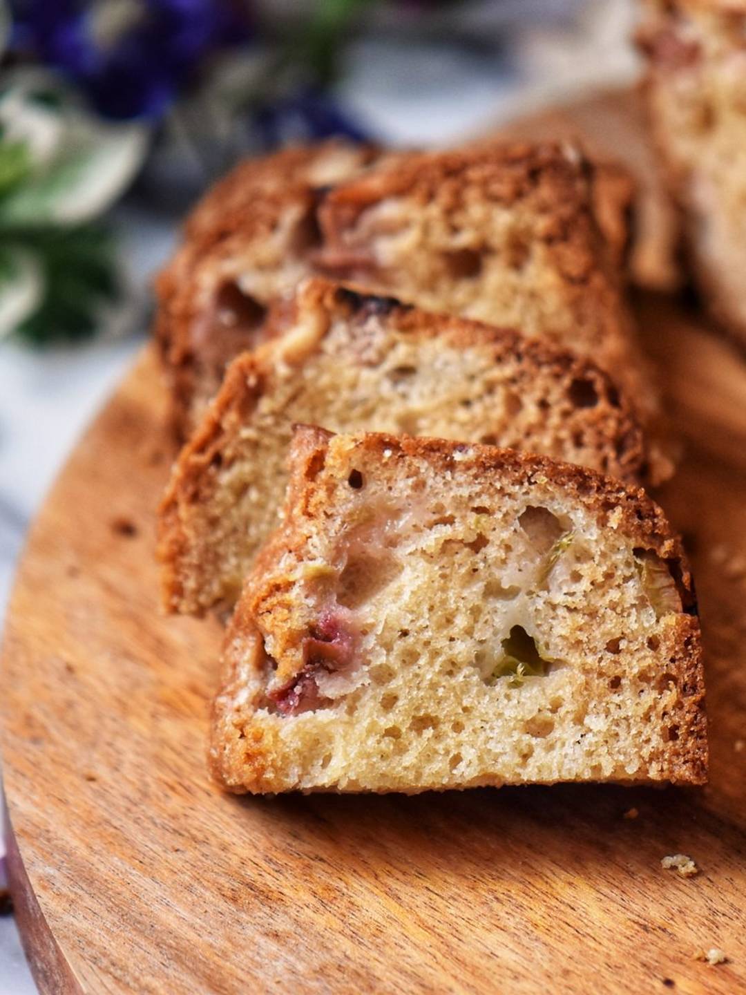 Slices of rhubarb cake in a wooden board.