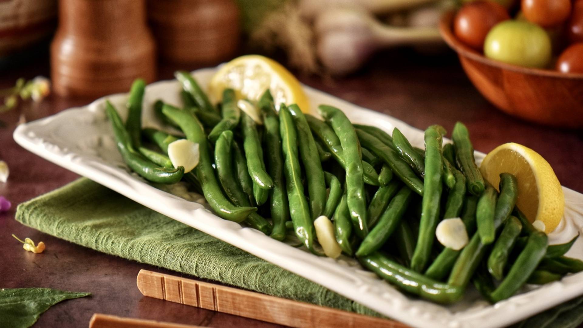 Green beans on a white serving platter.
