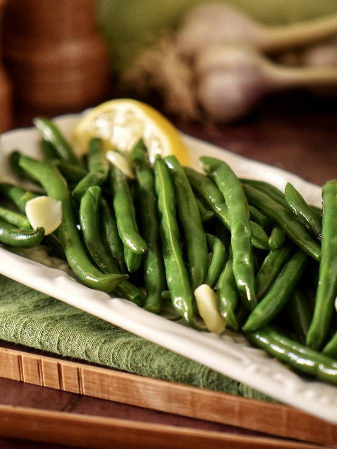 Green beans on a white serving platter.
