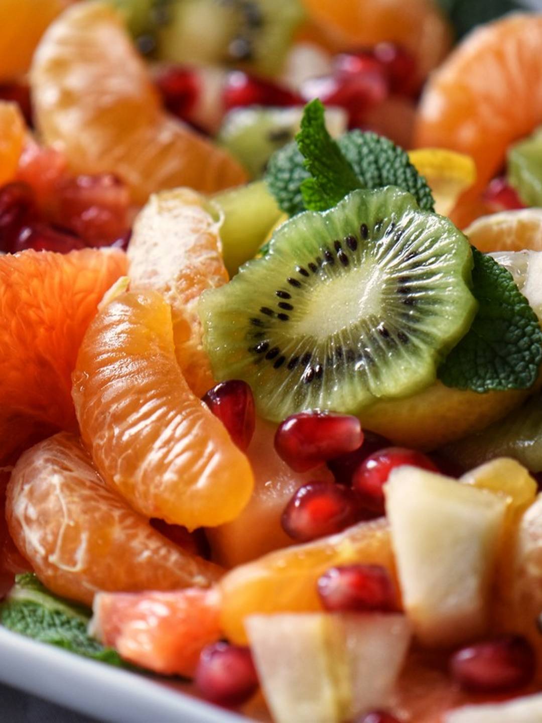 Fruit salad on a white platter.