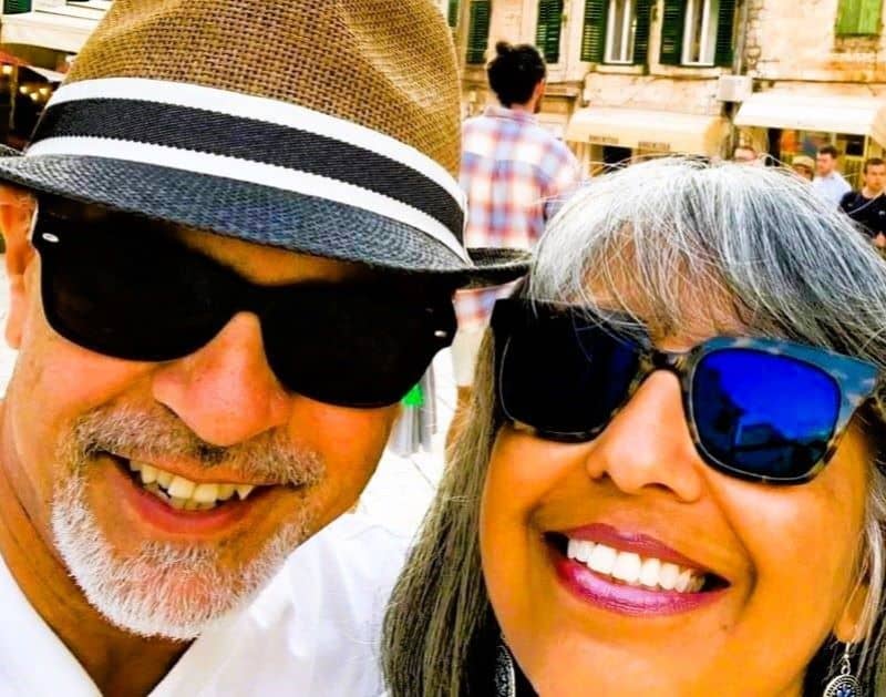 Photo of Nusi and Gijji smiling on a trip, founders of Passports & Bags travel blog