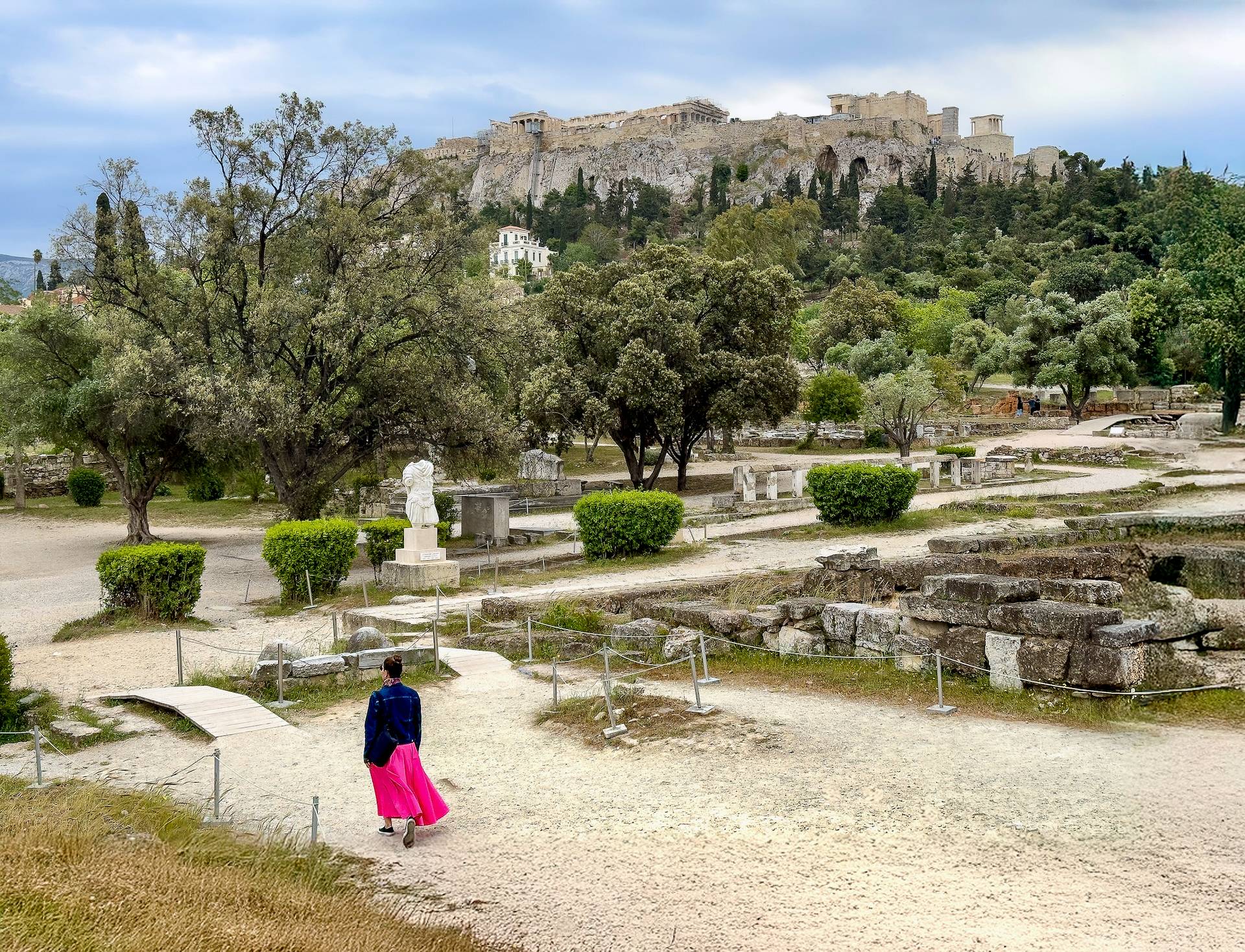 The author walking through the ancient agora of Athens with the Acropolis in the background