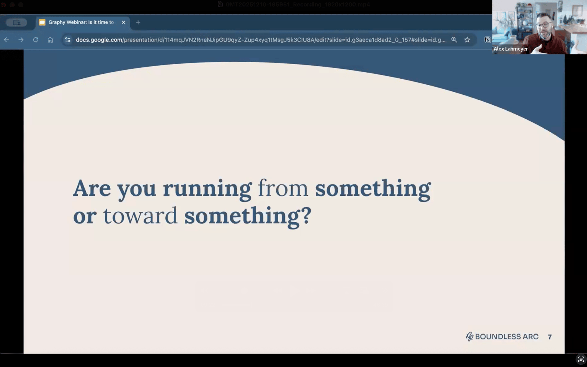 A screenshot of from Alex's webinar on side hustles. On the screen is a slide that says "Are you running from something or toward something?" with Alex's video in the top right corner. They're speaking and gesturing with their hands.