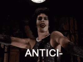 Gif of Frank-N-Furter from Rocky Horror saying "antici...pation"