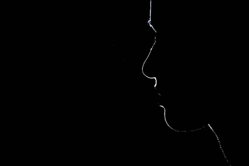 A silhouette of a person in the dark