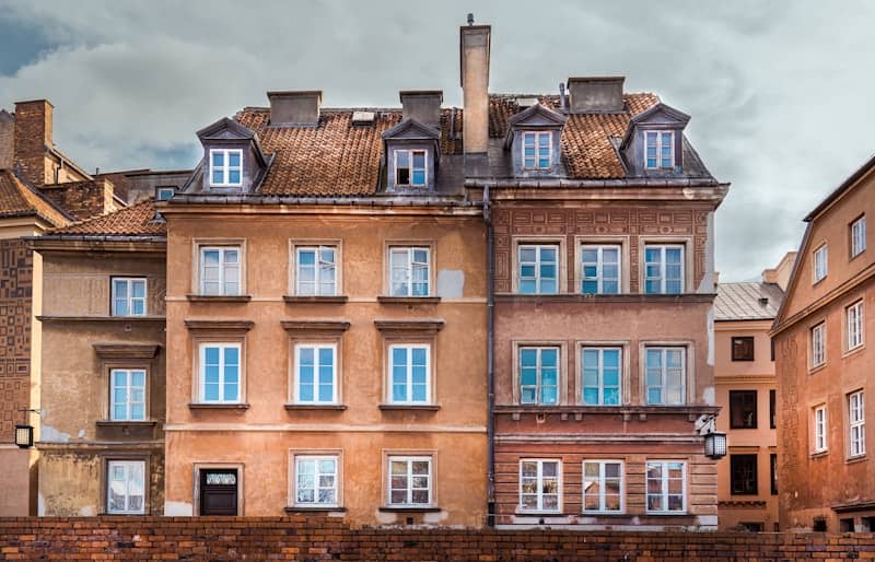 a large building with many windows and a clock on the front of it