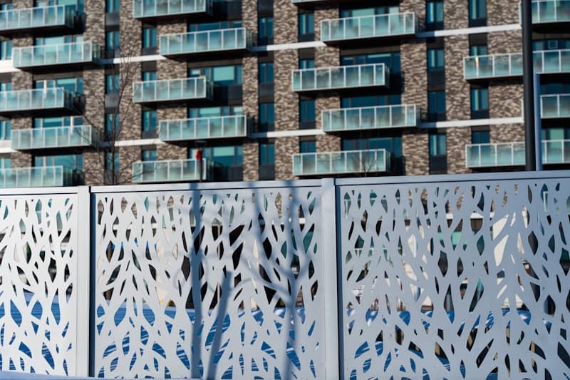 Modern apartment building behind decorative screen