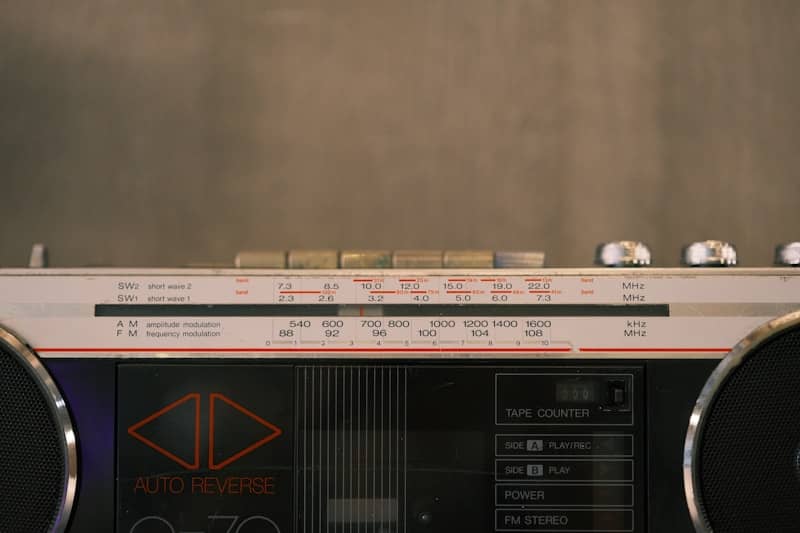 Here is a sentence: a vintage boombox is displayed in the picture.