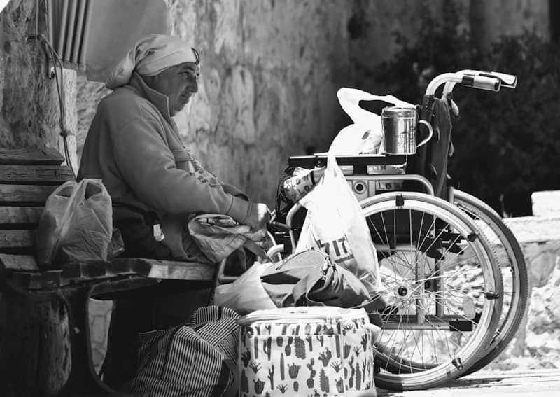 a man sitting on a bench next to a bike