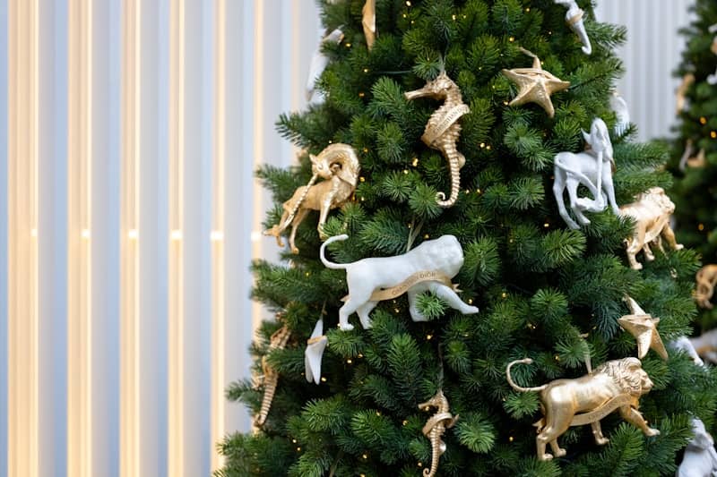 A christmas tree decorated with gold and white ornaments