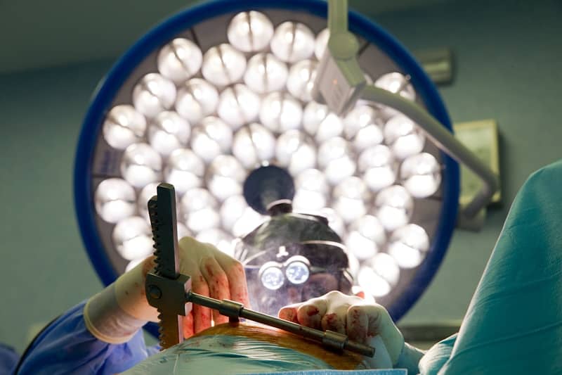 A person in a operating room operating a machine