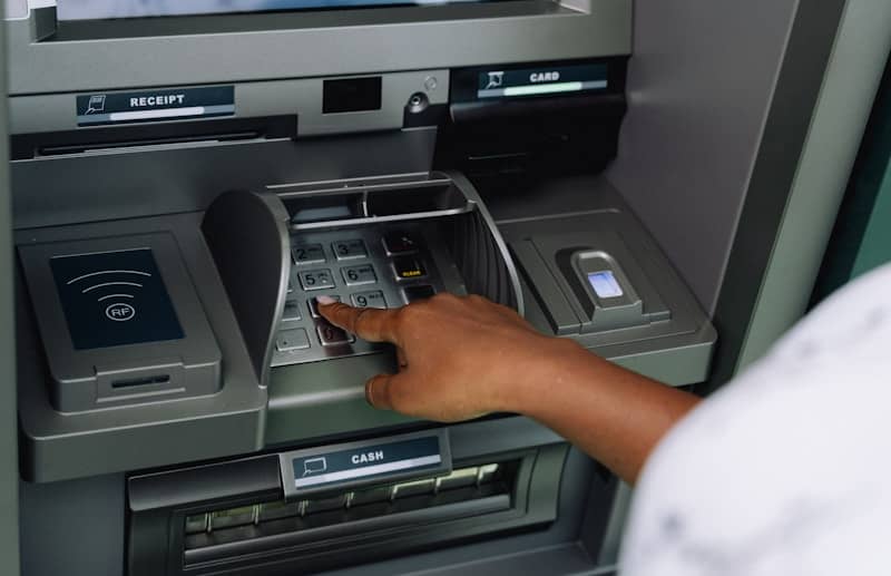 a person using an atm machine to pay money