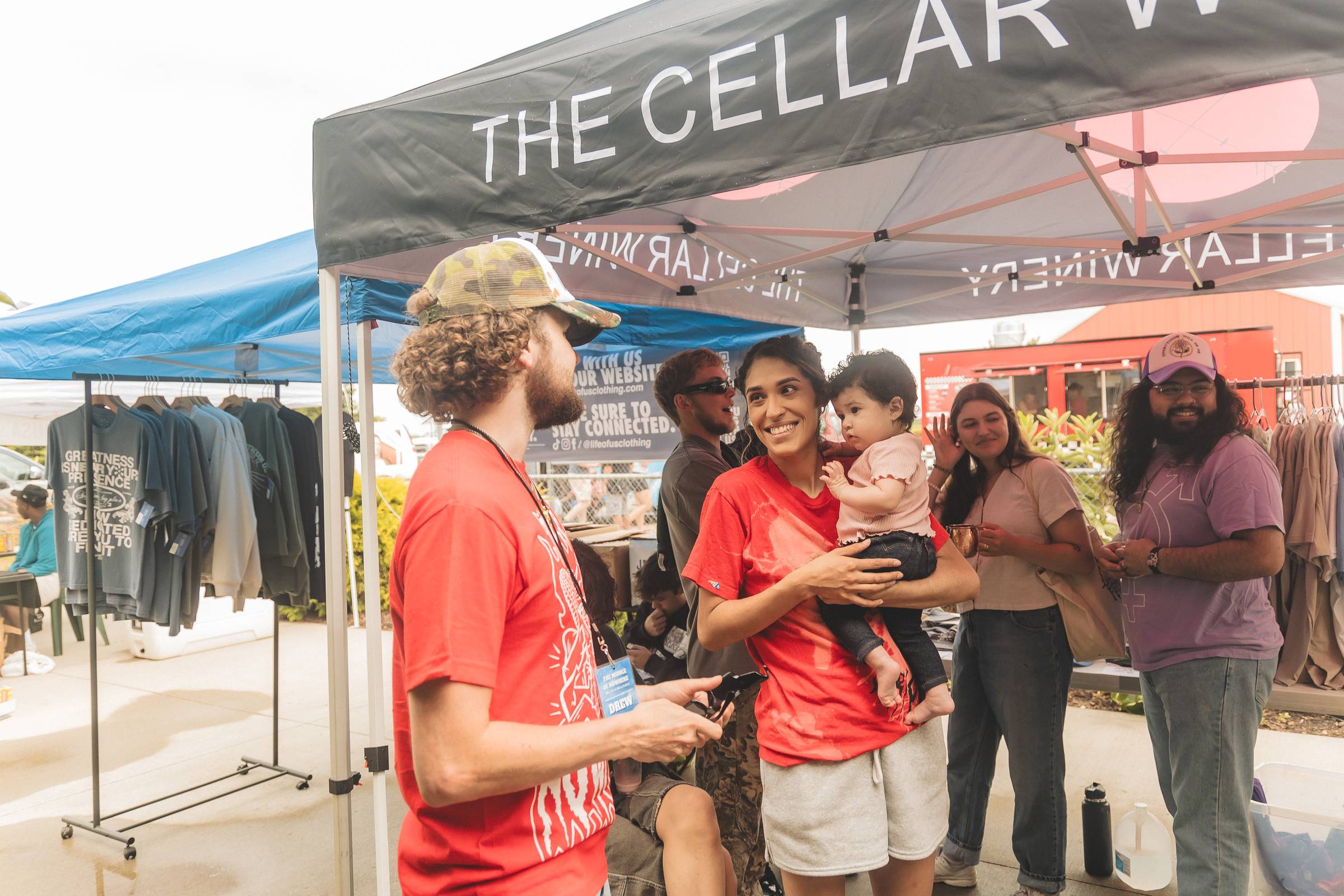 people gathering under a tent outside 