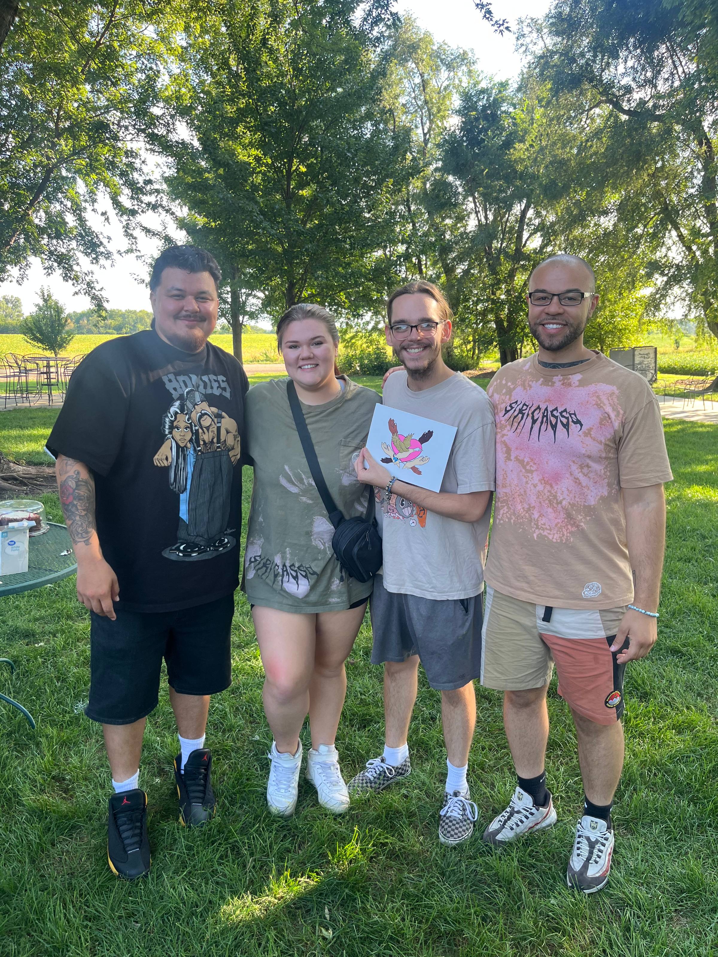 four individuals standing outside