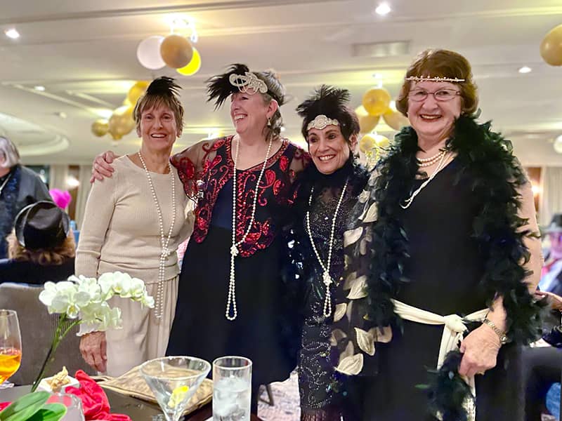 4 women dressed in roaring20s dress on a Tauck tour