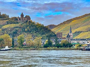a castle on a hill overlooking a river
