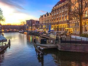 a canal and building at sunset