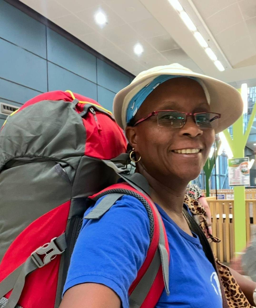 Traveller Carrying a backpack and smiling 