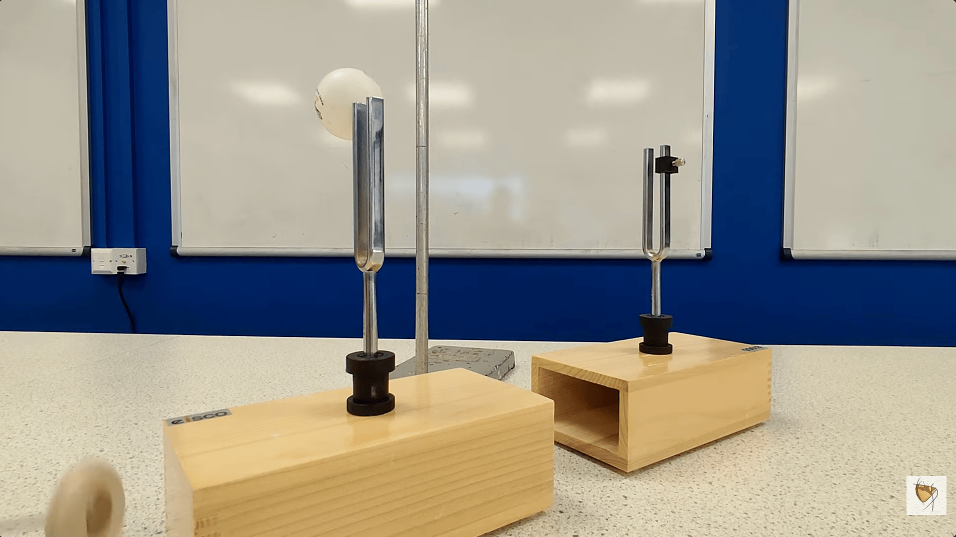 two tuning forks attached to boxes, showcasing the concept of resonance