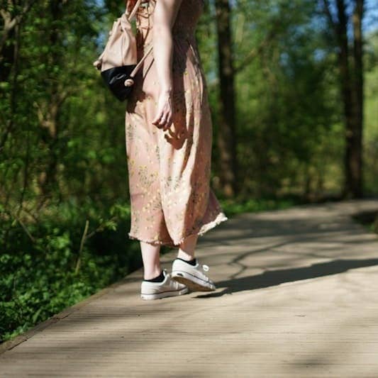 woman walking on forest trail