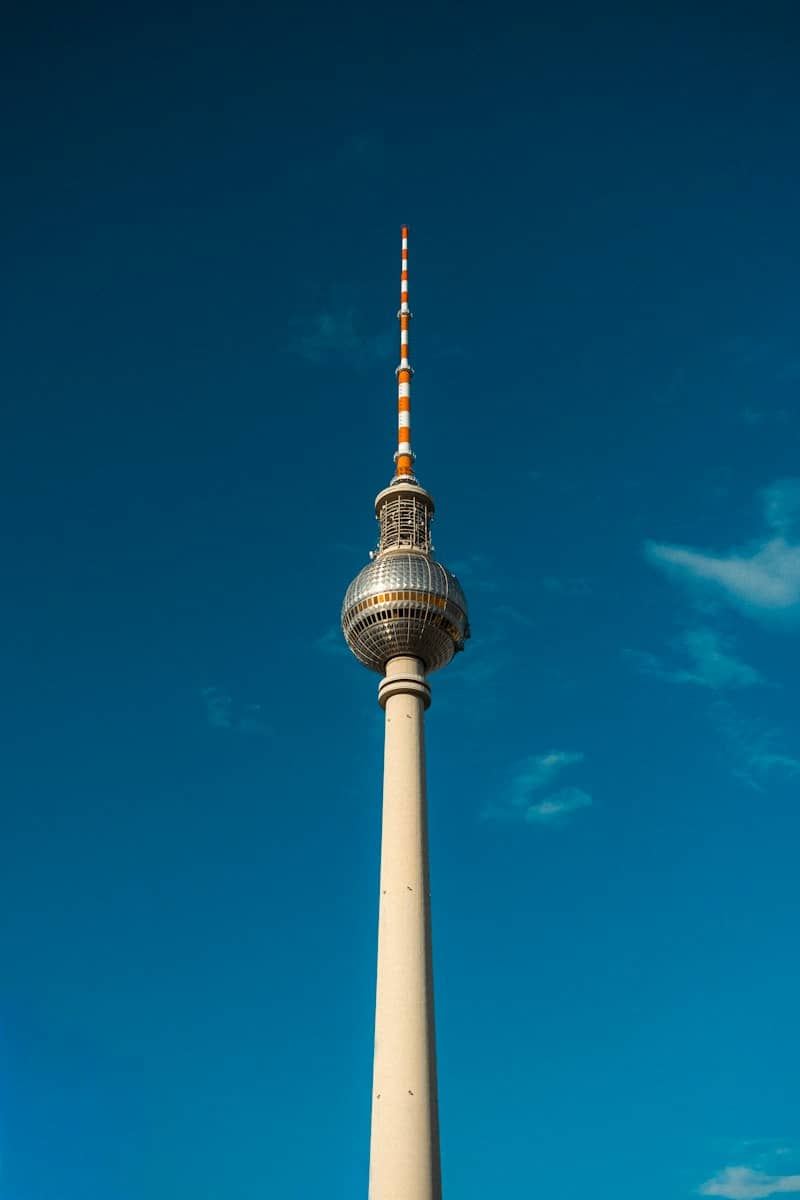 Tall television tower against a clear blue sky.