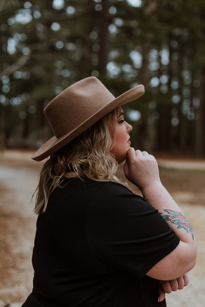 woman in black shirt wearing brown cowboy hat