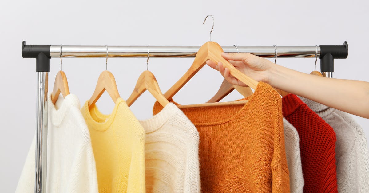 Sweaters hanging in a closet