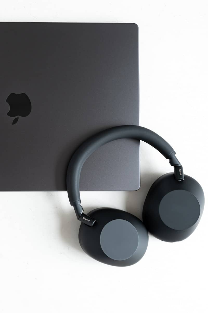 A laptop and headphones are pictured.